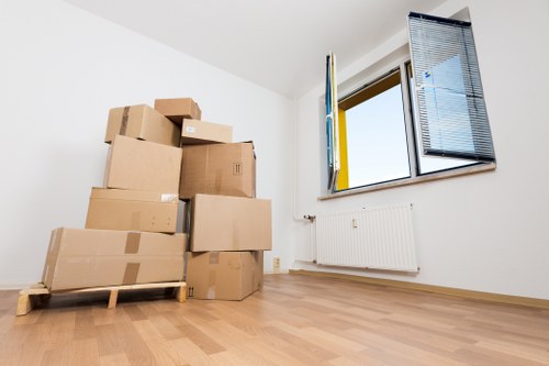 Packed moving boxes and wrapped furniture ready for a house removal service