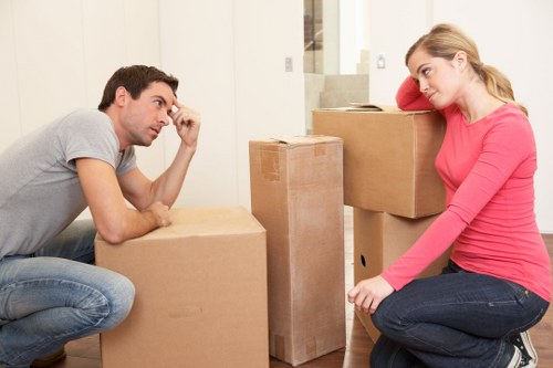 Professional movers placing office furniture in a new commercial space