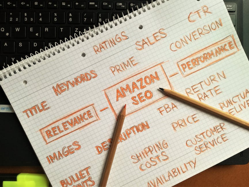 A close-up of a spiral-bound notepad with handwritten notes in orange ink, focusing on the keywords 'RELEVANCE' and 'AMAZON SEO' in the context of house removals and moving services. Surrounding these central terms are related words such as 'title,' 'keywords,' 'ratings,' 'sales,' 'conversion,' 'description,' 'images,' and 'performance,' with smaller notes like 'bullet points,' 'shipping costs,' 'return rate,' 'delivery,' 'pricing,' 'customer service,' and 'availability.' The notepad rests on a black keyboard, partially visible, indicating an office environment. Two wooden pencils are placed diagonally across the paper, pointing toward the handwritten keywords. The scene suggests planning and organising information related to moving logistics and service promotion, relevant to relocation companies like Man with Van Charing Cross.
